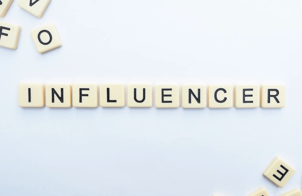 21 Ways to Repurpose Content with Influencer word spelled out in Scrabble blocks.