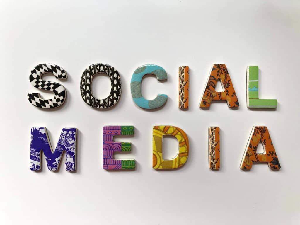 Social Media written in many colors on white background. Keep reading to learn how to convert social media into sales.