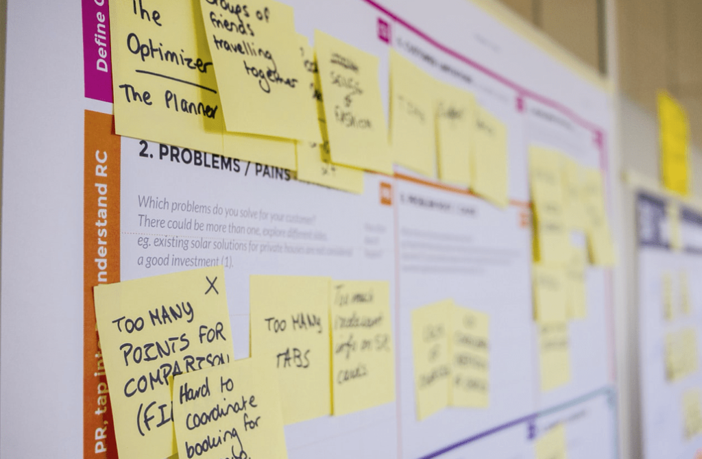 A picture of sticky notes on a board that a blogger is using to better understand their audience's content needs. Keep reading to learn more about the best strategies to curate content for your blog.