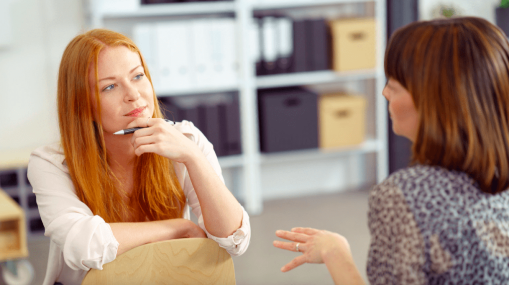 Persuade power words with ladies talking in a meeting.