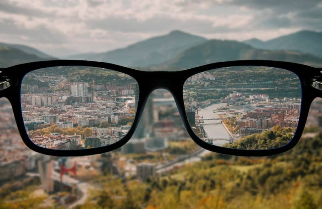 Looking through lenses of black glasses at a path ahead, symbolizing the importance having a vision for writing content. Keep reading to know how to write blog posts faster with a content plan.