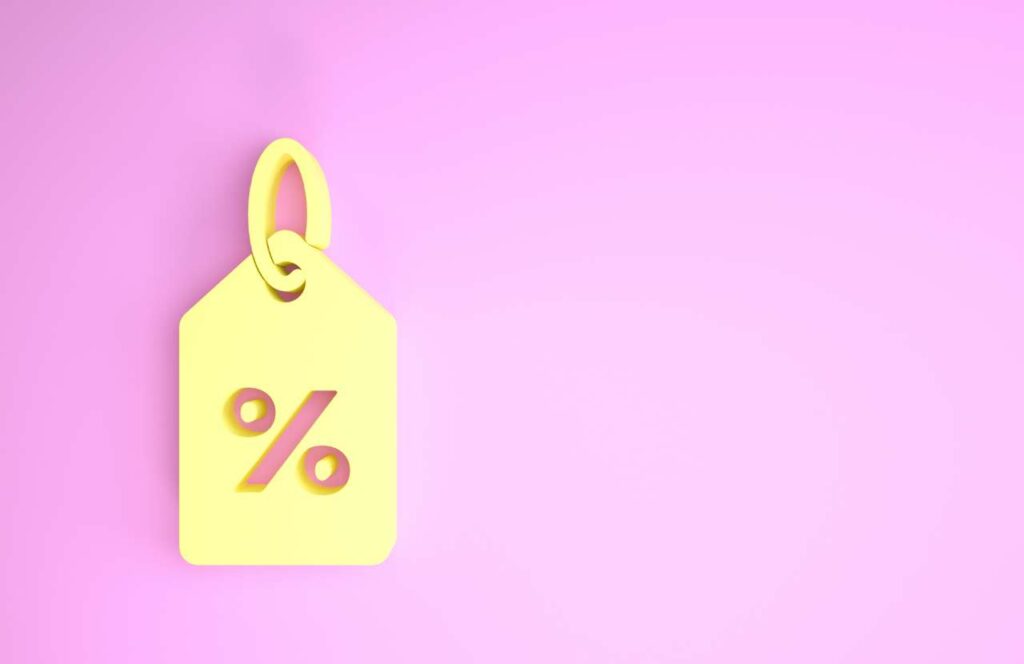 A yellow price tag with percentage sign on a pink background. If you want to learn how to build brand awareness for your blog, then keep reading.