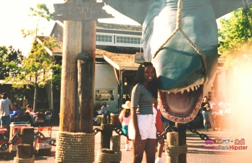 Universal-Orlando-Resort-NikkyJ-in-front-of-classic-Jaws-ride-standing-next-to-Bruce-the-shark-in-1997. Keep reading to learn how this theme park blogger and Disney blogger makes money.