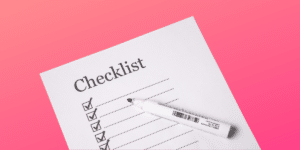 pink background with piece of paper titled "checklist"