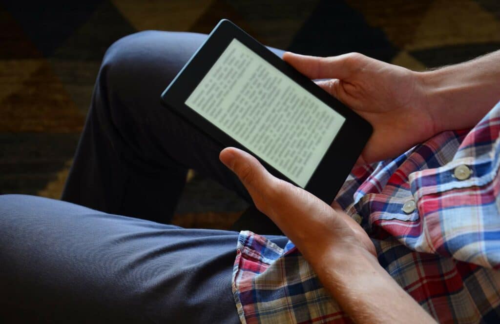 A man reading a free ebook he downloaded from a blog. Keep reading to learn how to monetize your blog from day one.