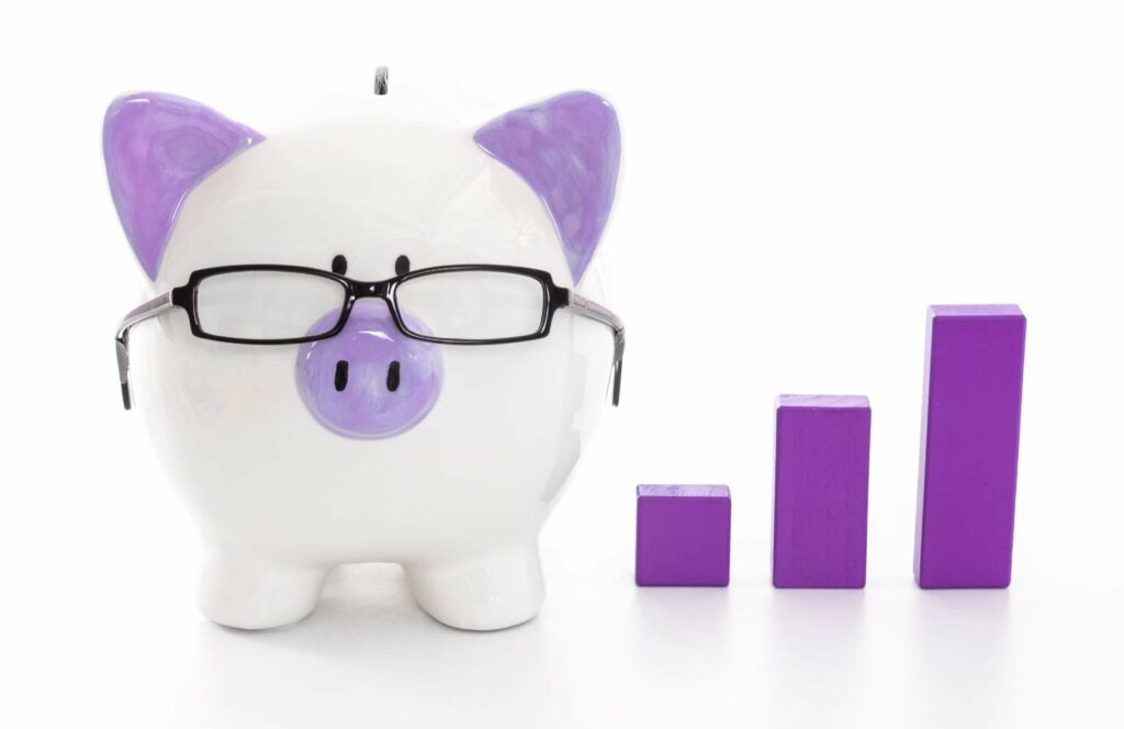 Piggy Bank next to purple graph. Keep reading to learn how to monetize your blog from day one.