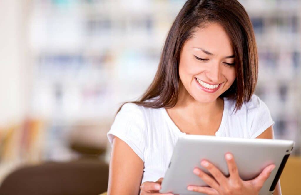 A woman reading a free ebook she downloaded from a blog. Keep reading to learn how to monetize your blog from day one.