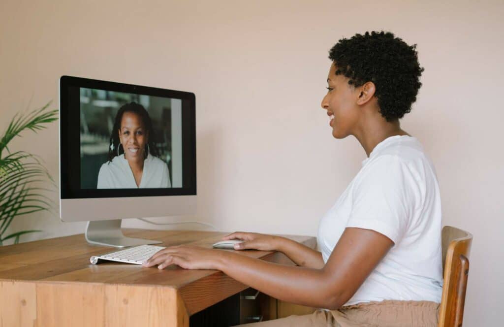 A woman sitting at her desk hosting a virtual summit from her blog audience. Keep reading to learn how to monetize your blog from day one.