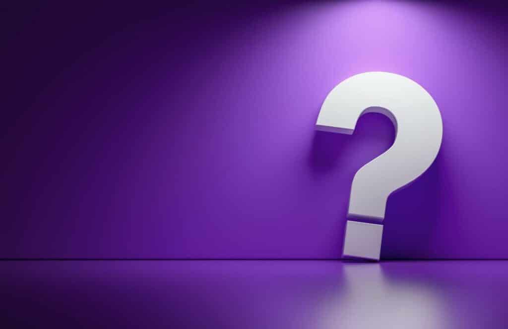 A large question mark on the left side of a purple wall background representing questions that are being asking about how to increase conversion rate on website.