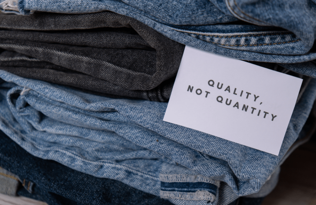 A stack of about four pairs of jeans with a card that reads "Quality not quantity," which is true for those who want to drive conversions, increase website traffic, and monetize their blogs. Keep reading to learn the answer to the question, "Is Blogging Still Relevant?"