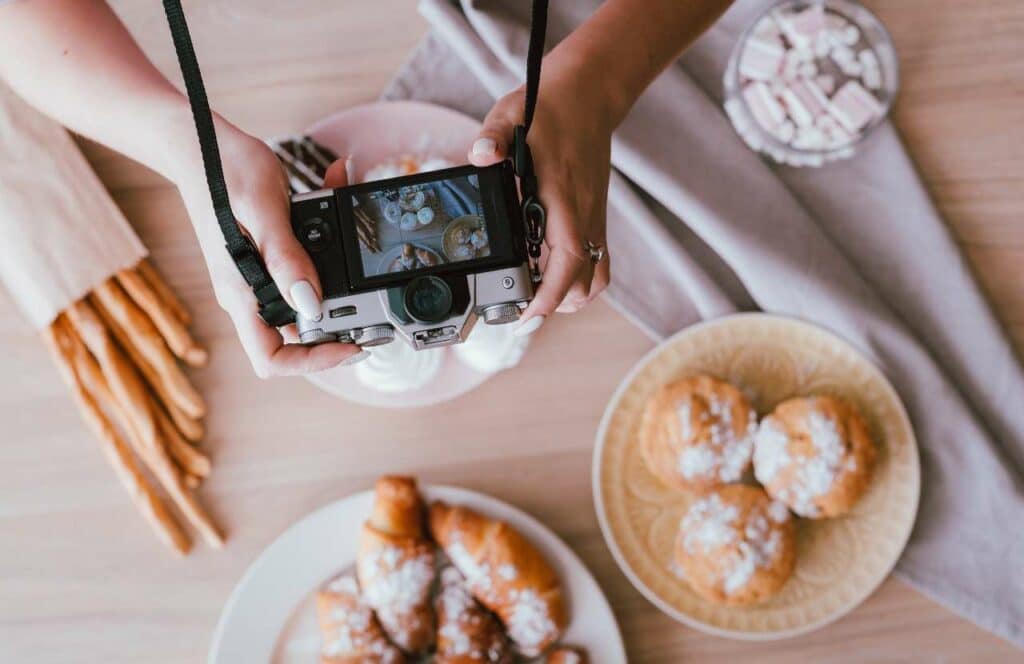 A woman taking photos of her latest baked goods for her food blog. If you have ever asked "What's the point of blogging?" click here to read more.