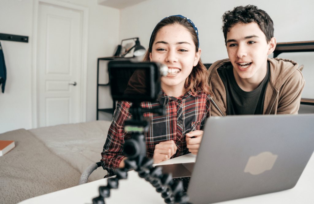 A young woman and young man creating blog content to delight their readers. If you've ever wondered "What's the point of blogging?" click here to read more.