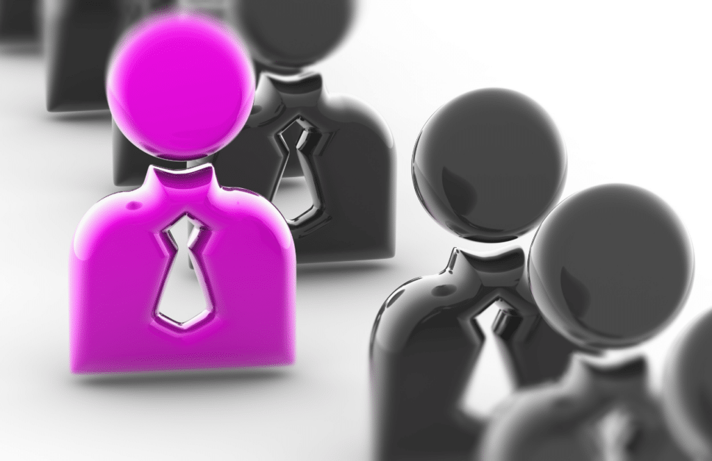 One person model standing out from the crowd with bright purple while everyone else is just grey. Learn how content can help you gain online visibility and jumpstart your business because content is king.