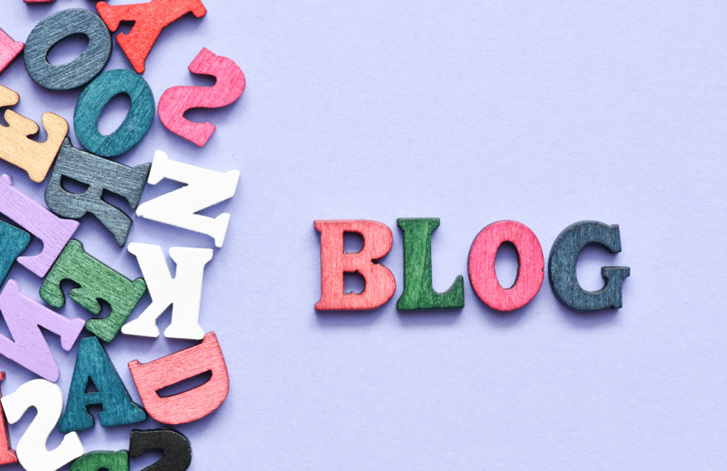 Wooden letters in a pile on left and the word blog spelled out on the right. Keep reading to learn the answer to the question, "Is Blogging Still Relevant?"