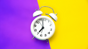 A timer clock on a purple and white background.